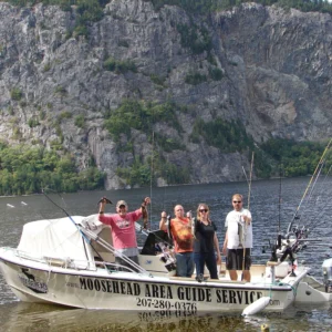 A group of people on a boat in the water.