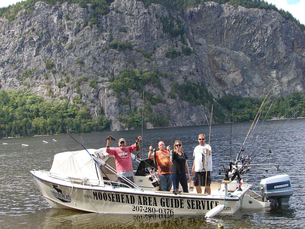 A group of people on a boat in the water.